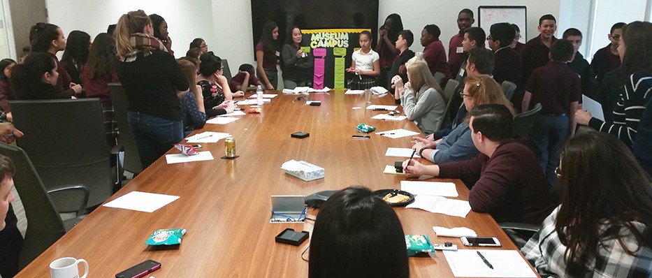 CICS Prairie sixth-graders watch as their classmates give a presentation to Cushman & Wakefield employees at their downtown office
